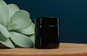 Dark blue background and natural wooden desk with plant leaf
